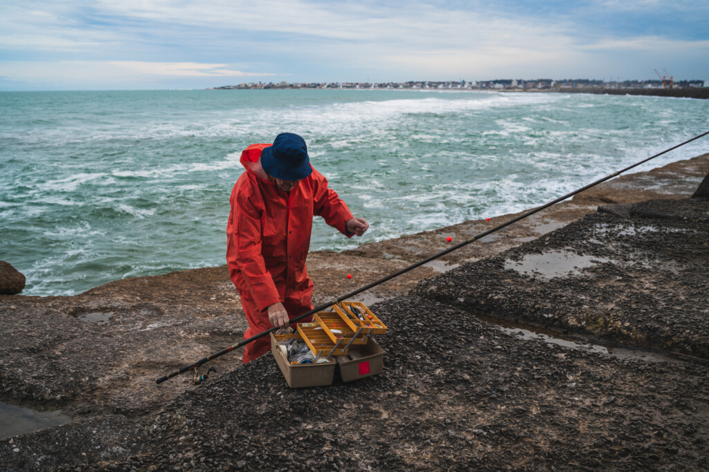 fisherman with fishing equipment box